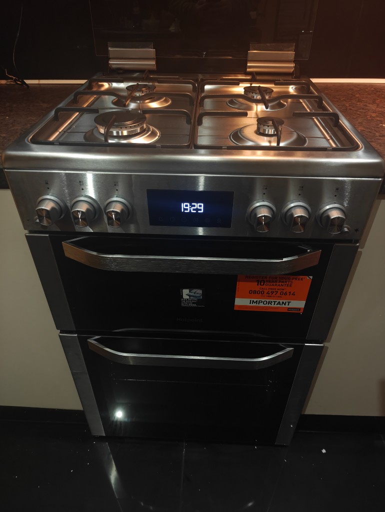 Stainless steel double oven cooker with digital clock display